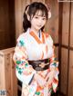 A woman in a kimono posing for a picture.