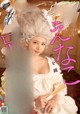 A woman in a white dress is posing for a magazine cover.