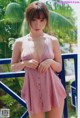 A woman in a red and white striped bathing suit posing for a picture.