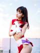 A woman in a red and white outfit posing for a picture.